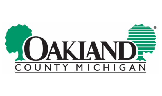 Two green trees and text Oakland County Michigan